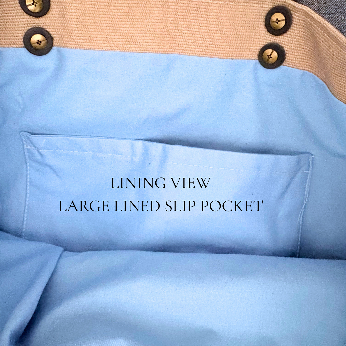 Close-up of a blue lining with a large slip pocket and beige trim with chicago screws showing