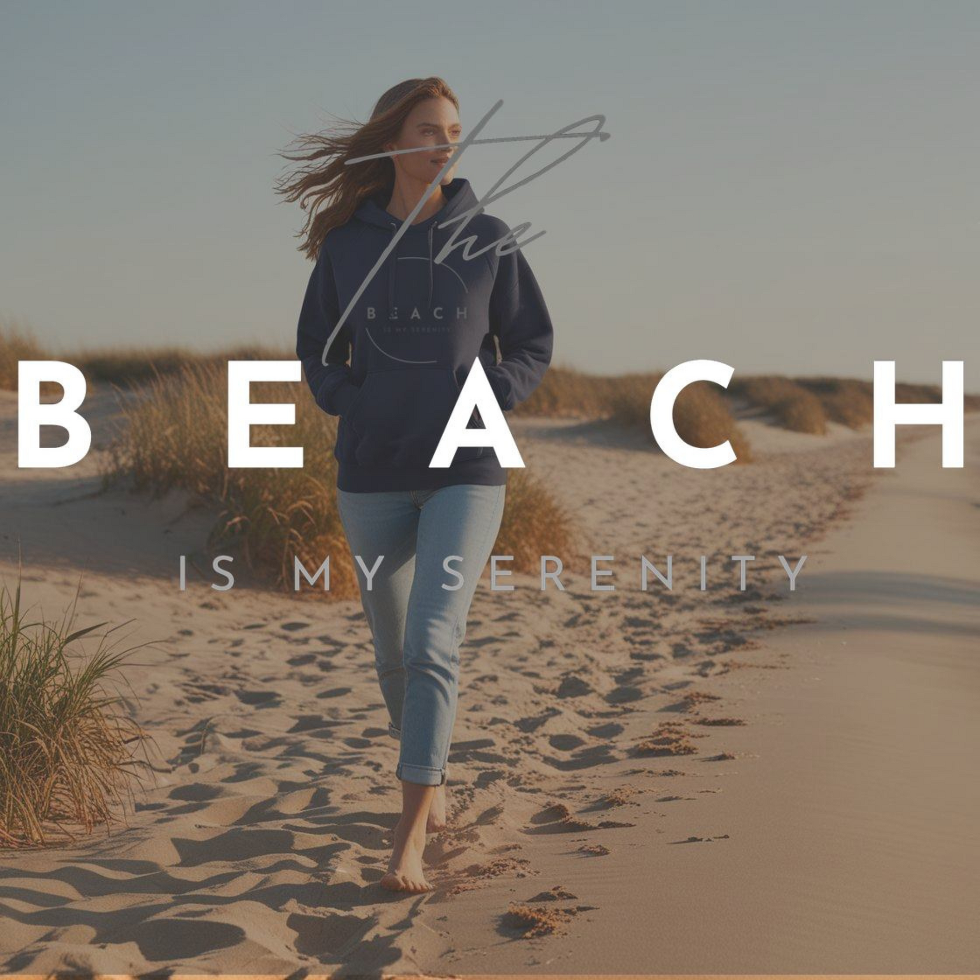 Girl in jeans and navy blue "the beach is my serenity" hoodie walking on the beach